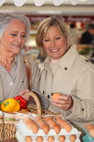 Photo: Mother and daughter shopping at the market together Mother and daughter shopping at the market together