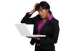 Businesswoman looking alarmed at her laptop