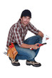 plumber holding a plastic pipe and a spanner