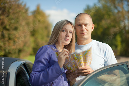 Photo: tourist couple looking at the map tourist couple looking at the map