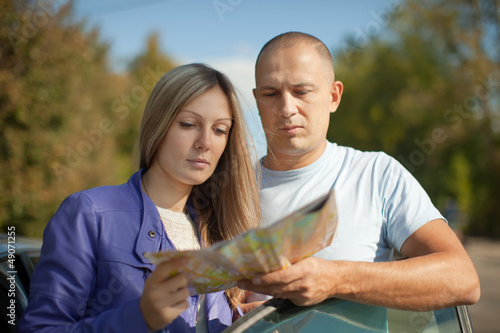 Photo: Traveler couple looking at the map Traveler couple looking at the map