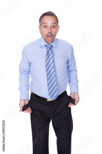 Photo: Businessman Showing Empty Pockets Businessman Showing Empty Pockets