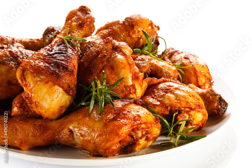 Photo: Grilled chicken legs on white background Grilled chicken legs on white background