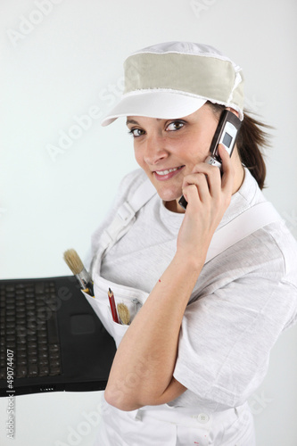 Photo: female painter making a call female painter making a call