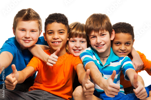 Photo: A row of five happy kids A row of five happy kids