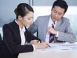 asian business people discussing sales performance