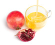 pomegranate and honey flowing in a cup of  glass on white