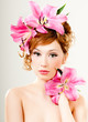 beautiful girl with pink lilies in her hair
