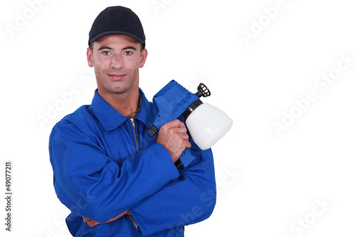 Photo: Man holding paint sprayer Man holding paint sprayer