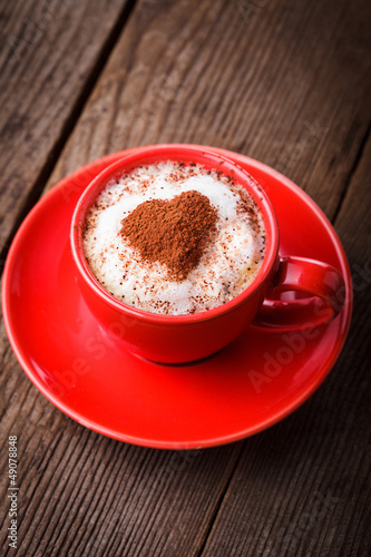 Photo: Red cup with cappuccino Red cup with cappuccino