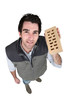 craftsman holding a brick