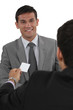 Businessman giving businesscard in a meeting