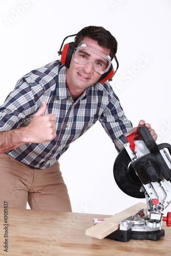 Photo: Man using a mitre saw Man using a mitre saw