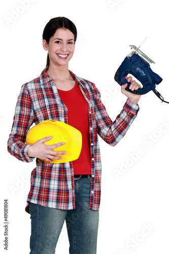 Photo: Woman with an electric jigsaw Woman with an electric jigsaw