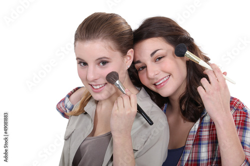 Photo: Two women applying make-up Two women applying make-up