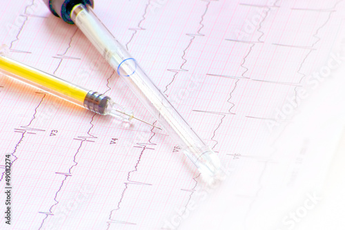 Photo: electrocardiogram with syringe and bottle electrocardiogram with syringe and bottle