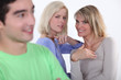 Two women gossiping about man
