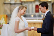 Bride and groom holding wedding rings