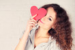 Beautiful girl holding heart shape