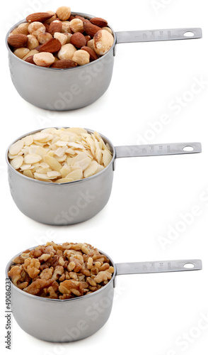 Photo: Whole nuts, flaked almonds and chopped walnuts in cup measures Whole nuts, flaked almonds and chopped walnuts in cup measures