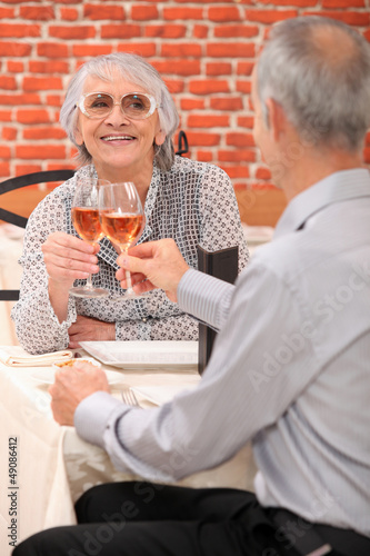 Photo: Mature couple toasting with rose wine Mature couple toasting with rose wine