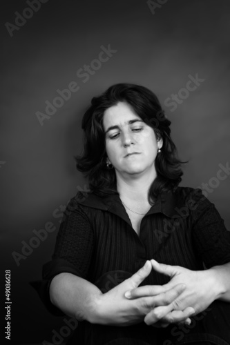 Photo: Black and white portrait of a sad woman sitting on the floor Black and white portrait of a sad woman sitting on the floor