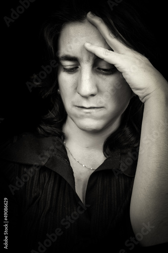 Photo: Black and white portrait of a sad hispanic woman with a headache Black and white portrait of a sad hispanic woman with a headache
