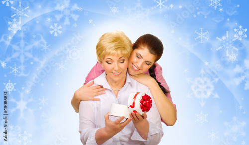 Photo: Young woman with her mother on winter background Young woman with her mother on winter background