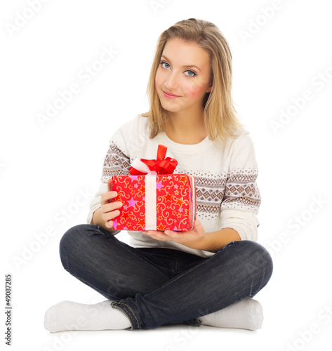 Photo: Young girl sit on the floor with gift box Young girl sit on the floor with gift box