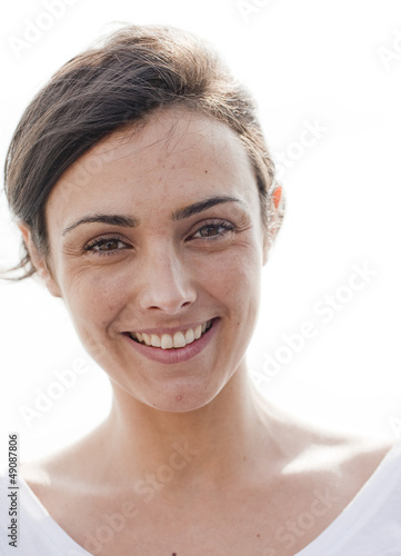 Photo: portrait of a natural young woman smiling portrait of a natural young woman smiling