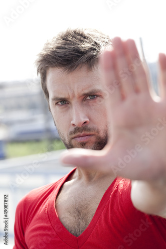 Photo: young man stopping all actions young man stopping all actions
