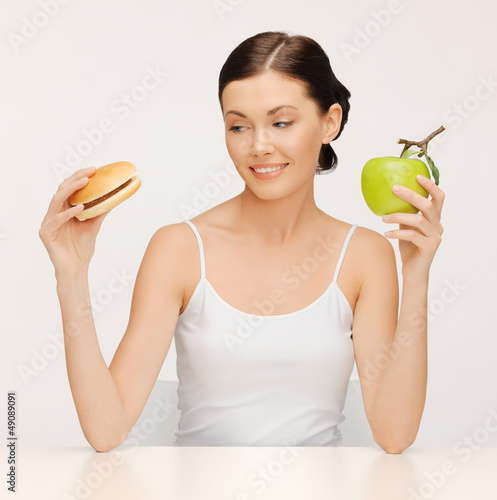Photo: woman with hamburger and apple woman with hamburger and apple