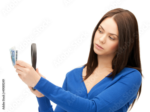 Photo: woman with magnifying glass and euro cash money woman with magnifying glass and euro cash money