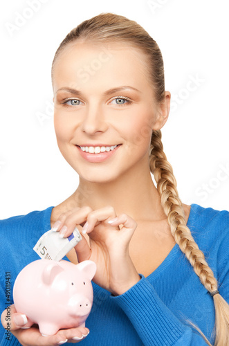 Photo: lovely woman with piggy bank and money lovely woman with piggy bank and money