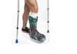 Man with a broken leg with Crutches on a white background
