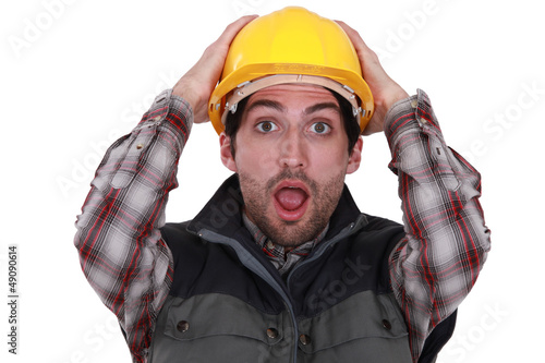 Photo: Worker holding her hands to her head Worker holding her hands to her head