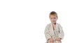 Karate boy exercising isolated against white background
