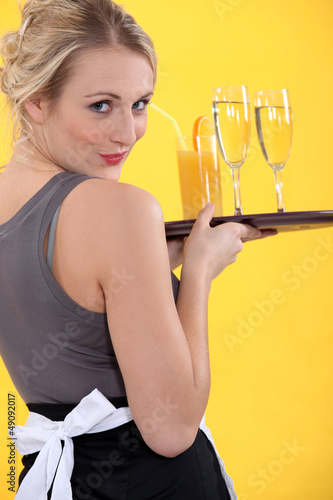 Photo: Attractive waitress serving drinks Attractive waitress serving drinks