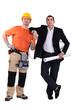 Engineer and construction worker standing side by side