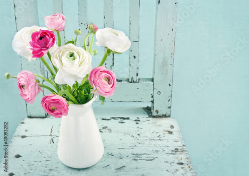 Photo: White and pink flowers on light blue chair White and pink flowers on light blue chair