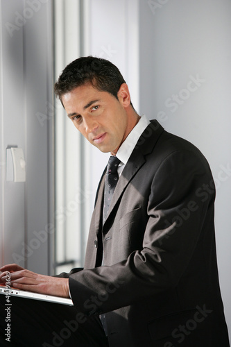 Photo: Confident businessman using a laptop Confident businessman using a laptop