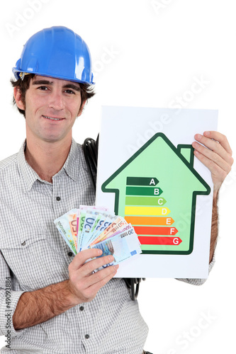 Photo: manual worker holding cash and energy information manual worker holding cash and energy information