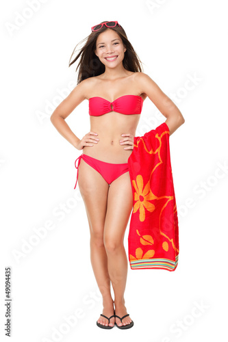 Photo: Bikini vacation holidays woman standing isolated Bikini vacation holidays woman standing isolated