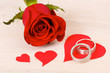 rose with wedding rings