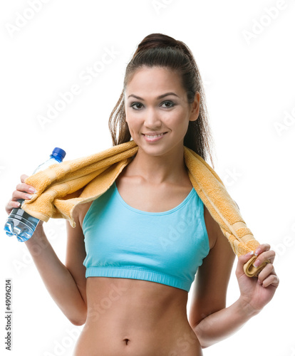 Photo: Sportive woman with bottle of water and yellow towel Sportive woman with bottle of water and yellow towel