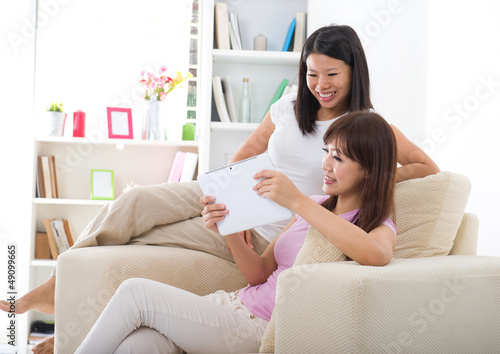 Photo: chinese female friends having a good time in living room chinese female friends having a good time in living room