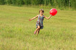 The girl running across the field in summer day