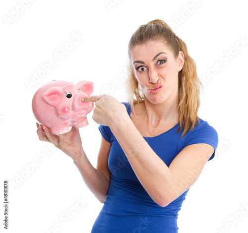 Photo: Ungeliebtes Sparschwein - Frau mit Grimasse und Spardose Ungeliebtes Sparschwein - Frau mit Grimasse und Spardose
