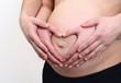 pregnant belly with hands om mom and dad