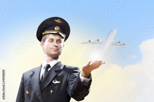 Photo: Image of pilot with plane in hand Image of pilot with plane in hand